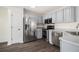 Modern kitchen featuring stainless steel appliances and grey cabinets at 142 Parkside Dr, Stockbridge, GA 30281