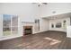 Bright living room with large windows, hardwood floors, and a cozy fireplace at 142 Parkside Dr, Stockbridge, GA 30281
