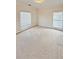 Neutral carpeted bedroom featuring two windows, providing ample natural light at 1890 Glenhurst Dr, Snellville, GA 30078