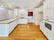 Well-lit kitchen featuring white cabinets, hardwood floors, and modern appliances at 1890 Glenhurst Dr, Snellville, GA 30078