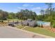 Aerial view of community pool and clubhouse with ample parking and playground at 221 Kindness Cir, Mcdonough, GA 30252