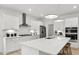 Modern kitchen with white cabinets, stainless steel appliances, a large island, and pendant lighting at 221 Kindness Cir, Mcdonough, GA 30252