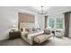 Serene main bedroom featuring a padded headboard, soft lighting, and neutral decor for a restful retreat at 221 Kindness Cir, Mcdonough, GA 30252