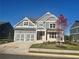 Stunning two-story home featuring a two-car garage and a beautifully landscaped front yard at 320 Willow Cv, Canton, GA 30114