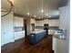 Bright kitchen featuring stainless steel appliances, a gray island, and hardwood floors at 320 Willow Cv, Canton, GA 30114