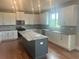 Spacious kitchen with a large center island, modern appliances, and ample cabinet space at 320 Willow Cv, Canton, GA 30114
