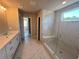 Modern bathroom with a double sink vanity, a large glass shower, and elegant tile work at 320 Willow Cv, Canton, GA 30114