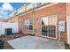 A brick exterior with a sliding glass door and a small concrete patio at 3815 Pleasant Oaks Dr, Lawrenceville, GA 30044