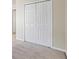 Bedroom closet with white, paneled doors and neutral carpet at 3815 Pleasant Oaks Dr, Lawrenceville, GA 30044