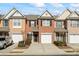 Traditional red brick townhome featuring a single-car garage and a well-maintained front yard with manicured shrubbery at 3815 Pleasant Oaks Dr, Lawrenceville, GA 30044