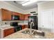 Well-equipped kitchen with granite countertops, stainless steel appliances, and dark wood cabinetry at 3815 Pleasant Oaks Dr, Lawrenceville, GA 30044