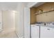 Convenient laundry area with washer, dryer, and shelving at 3815 Pleasant Oaks Dr, Lawrenceville, GA 30044
