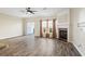 Spacious living area featuring wood floors, a cozy fireplace, and sliding doors to a private outdoor space at 3815 Pleasant Oaks Dr, Lawrenceville, GA 30044