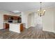 Open-concept living space with wood floors, granite countertops, and seamless flow from kitchen to dining area at 3815 Pleasant Oaks Dr, Lawrenceville, GA 30044