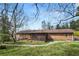 Expansive backyard featuring a patio and mature landscaping surrounding the brick home at 422 Derbyshire Dr, Stone Mountain, GA 30088