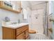 Bathroom featuring a wooden vanity and a combination shower and tub with updated tiling at 422 Derbyshire Dr, Stone Mountain, GA 30088