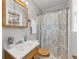 Cozy bathroom featuring a wood vanity with solid surface countertop, decorative shower curtain, and natural light at 422 Derbyshire Dr, Stone Mountain, GA 30088