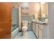 Bathroom featuring blue tile surround, coordinated tub, and a white sink at 422 Derbyshire Dr, Stone Mountain, GA 30088