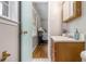 Bathroom with hardwood floors, vanity and window, with a bedroom and bed beyond the open door at 422 Derbyshire Dr, Stone Mountain, GA 30088