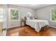 Bedroom with hardwood floors and natural light from dual windows overlooking the yard at 422 Derbyshire Dr, Stone Mountain, GA 30088