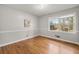 Cozy bedroom with hardwood floors and a bright window view at 422 Derbyshire Dr, Stone Mountain, GA 30088