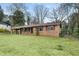 Quaint brick home with mature trees and green lawn at 422 Derbyshire Dr, Stone Mountain, GA 30088