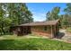Quaint brick home with mature trees and screened in porch perfect for enjoying nature at 422 Derbyshire Dr, Stone Mountain, GA 30088