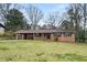 Charming single-story brick home with covered parking and a spacious front yard with great potential at 422 Derbyshire Dr, Stone Mountain, GA 30088
