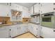 Functional kitchen with white cabinets, updated appliances, and ample counter space at 422 Derbyshire Dr, Stone Mountain, GA 30088