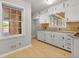 Bright kitchen featuring classic white cabinets, lots of natural light and hardwood floors at 422 Derbyshire Dr, Stone Mountain, GA 30088
