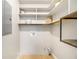 Pantry with wood-trimmed shelving, plus a white wall with electrical outlets and ventilation at 422 Derbyshire Dr, Stone Mountain, GA 30088