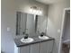 Bathroom featuring dual sinks, granite counters, and dual mirrors at 6023 Kingston Wood Way, Lithonia, GA 30038