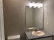 Bathroom featuring a granite counter, mirror, sink, and a modern four-light light fixture at 6023 Kingston Wood Way, Lithonia, GA 30038