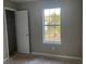 Bedroom with a view to the outside and an adjacent door at 6023 Kingston Wood Way, Lithonia, GA 30038