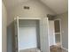 A white door and an open closet create an inviting bedroom space at 6023 Kingston Wood Way, Lithonia, GA 30038