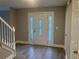 Bright foyer featuring a decorative front door and wood-look floors at 6023 Kingston Wood Way, Lithonia, GA 30038