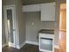 Kitchen featuring white cabinets, granite countertops, and a stainless steel refrigerator at 6023 Kingston Wood Way, Lithonia, GA 30038