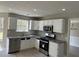 Bright kitchen featuring white cabinets, stainless steel appliances, and granite countertops at 6023 Kingston Wood Way, Lithonia, GA 30038