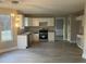 The bright kitchen is fitted with white cabinets, stainless steel appliances, and granite counters at 6023 Kingston Wood Way, Lithonia, GA 30038