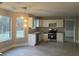 Spacious kitchen boasts white cabinets, stainless appliances, granite counters, and natural light at 6023 Kingston Wood Way, Lithonia, GA 30038