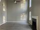 Bright living room with a fireplace, high ceilings, and large windows at 6023 Kingston Wood Way, Lithonia, GA 30038