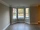 Cozy living room with bay windows, providing ample natural light at 6023 Kingston Wood Way, Lithonia, GA 30038