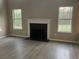 Living room features a fireplace and windows overlooking a green yard at 6023 Kingston Wood Way, Lithonia, GA 30038