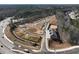 An aerial view of new home construction in a wooded area, including the road and landscaping at 4655 Larkfield Way, Powder Springs, GA 30127