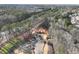 An aerial view of a new construction in a wooded area with newly installed driveway and landscaping at 4655 Larkfield Way, Powder Springs, GA 30127