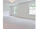 Spacious bedroom with neutral carpeting and natural light from two windows at 4655 Larkfield Way, Powder Springs, GA 30127