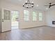 Light-filled living room with wood-look floors, backyard access, and a modern ceiling fan at 4655 Larkfield Way, Powder Springs, GA 30127