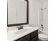 Bright bathroom with white countertop, dark wood vanity, and shower-tub combination at 5310 Corinth Ct, Cumming, GA 30040