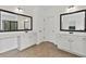 Double vanity in a bright bathroom with tile floors and decorative mirrors at 5310 Corinth Ct, Cumming, GA 30040