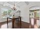 Bright dining area with modern chandelier, complemented by hardwood floors and sunlit window at 5310 Corinth Ct, Cumming, GA 30040